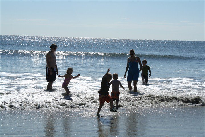 Family playing in the ocean waves